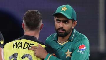 Pakistan's captain Babar Azam, right congratulates Australia's Matthew Wade on their win during the 