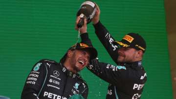 Mercedes driver Lewis Hamilton, of Britain, celebrates his first place victory in the Brazilian Form
