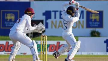 Sri Lankan batsman Dhananjaya de Silva las a shot as West Indies' wicketkeeper Dhananjaya de Silva w