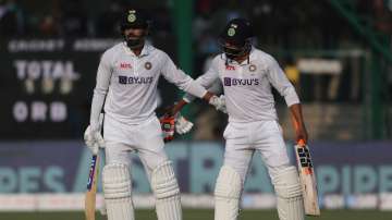 India's Shreyas Iyer is congratulated by his teammate Ravindra Jadeja, right, after he scored 50 run
