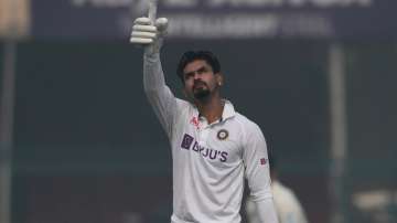 India's Shreyas Iyer raises his bat after scoring a century on Day 1 the first Test against New Zeal