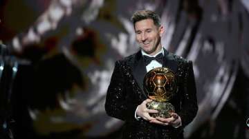 Lionel Messi reacts after winning the 2021 Ballon d'Or trophy at Theatre du Chatelet, in Paris on Mo