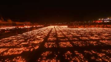 Devotees light earthen lamps on the bank of Saryu River during Deepotsav celebrations in Ayodhya.