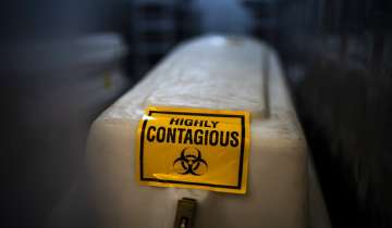 A sealed coffin containing the remains of a COVID-19 victim is stored in a refrigerated container in Johannesburg.