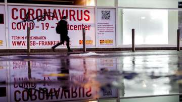 A woman walks past an abandoned coronavirus test center in Frankfurt. Numbers of coronavirus infections are rising again in Germany.