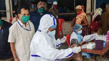 A medic takes samples from a man at a free COVID-19 rapid antigen testing camp in Thane.