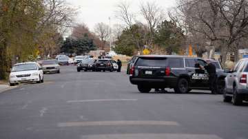 Law enforcement officers survey the scene of a drive-by shooting that left six teenagers injured in a park.