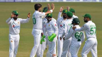 Pakistan's players celebrate after the dismissal of Bangladesh's Saif Hassan (not pictured) during the first day of the first Test cricket match between Bangladesh and Pakistan at the Zahur Ahmed Chowdhury Stadium in Chittagong on November 26, 2021.