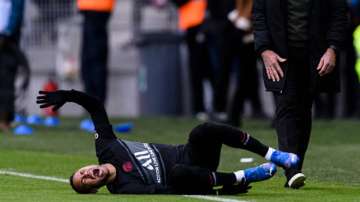 Neymar Jr of Paris Saint Germain (left) lies injured during the Ligue 1 Uber Eats match between AS S