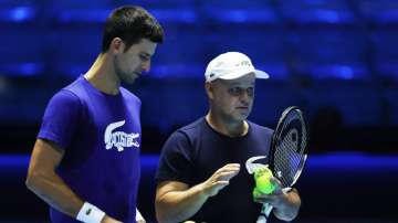 Novak Djokovic of Serbia with his coach Marian Vajda during a practice session ahead of the Nitto AT