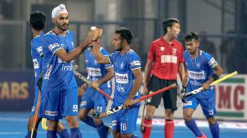 Indian hockey players celeberate after scoring a goal against Canada during a group stage match of F