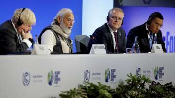 Britain's Prime Minister Boris Johnson, left, Prime Minister Narendra Modi, second left, Australia's Prime Minister Scott Morrison and Jamaica's Prime Minister Andrew Holness, right, attend a meeting during the UN Climate Change Conference COP26 in Glasgow, Scotland