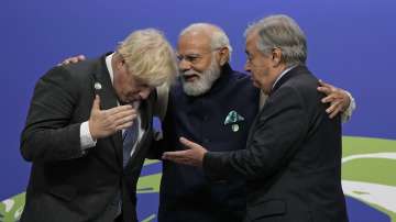 British Prime Minister Boris Johnson, left, and UN Secretary-General Antonio Guterres, right, greet India Prime Minister Narendra Modi at the COP26 U.N. Climate Summit in Glasgow, Scotland, Monday, Nov. 1, 2021. 