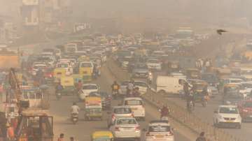 Vehicles ply amid low visibility due to a thick layer of smog in Gurugram.