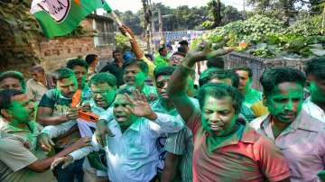 Trinamool Congress (TMC) activists celebrate as the party is leading during the counting of votes of all four West Bengal assembly constituencies , in Nadia