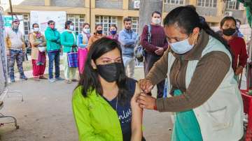 A health worker inoculates a dose of Covid-19 vaccine to a beneficiary.