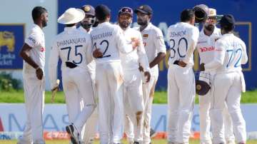 Members of Sri Lankan cricket team celebrate their 164-run victory over West Indies.