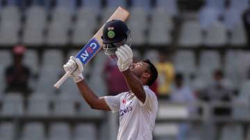 India's Mayank Agarwal celebrates scoring a century in Mumbai Test.