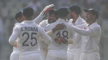 India's Mohammed Siraj,center, celebrates the dismissal of New Zealand's Ross Taylor with his team players during day two of their second test cricket match with New Zealand in Mumbai