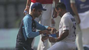 India's Mayank Agarwal (right) is attended by team physiotherapist Nitin Patel during the Day three 