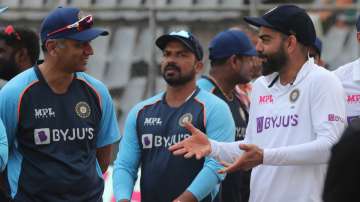 India's Virat Kohli , right, speaks with coach Rahul Dravid , left, after winning on the day four of