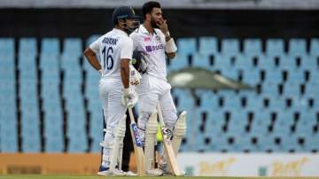 India's Mayank Agarwal with teammate KL Rahul watch the electronic screen as the TV umpire reviews a