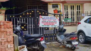 A poster stating containment zone at the residence of 46-year-old doctor who was detected with the Omicron variant of Covid-19, in Bengaluru, Friday