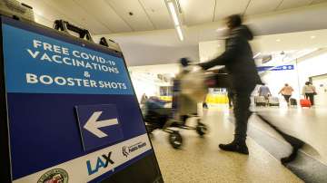 A Free COVID-19 Vaccination and Booster Shots sign is posted at the Los Angeles International Airport in Los Angeles.