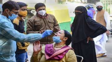 New Delhi: A health official takes swab sample of a person on a street for COVID-19 test, amid concern over rising Omicron cases, in New Delhi