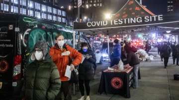 People wait on line to get tested for COVID-19 on the Lower East Side of Manhattan, Tuesday, Dec. 21, 2021, in New York. 