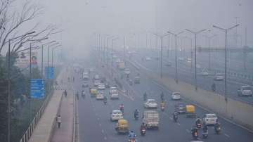 Vehicles ply amid an atmosphere shrouded in smog in New Delhi 