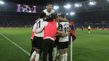 Carlos Soler celebrating with his teammates after scoring a goal