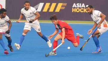 South Korea's Hwang Taeil (in red) dodges past Indian players during Asian Championship Trophy group