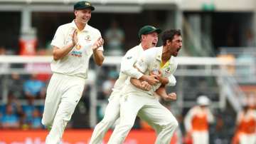 Australia pacer Mitchell Starc (far right) celebrates with teammates after dismissing England opener Rory Burns on Day one of the First Ashes Test at The Gabba in Brisbane Wednesday.