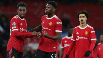 Manchester United's Anthony Elanga and Teden Mengi walk off after the UEFA Champions League group F 