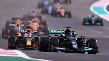 Lewis Hamilton, driving the (44) Mercedes AMG Petronas F1 Team Mercedes W12, leads Max Verstappen, driving the (33) Red Bull Racing RB16B Honda, and the rest of the field at the start of the Abu Dhabi GP at Yas Marina Circuit on Sunday.
