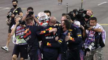 ?Race winner Max Verstappen of Netherlands and Red Bull Racing celebrates with his team at parc ferme during the F1 Grand Prix of Abu Dhabi at Yas Marina Circuit on December 12, 2021 in Abu Dhabi, United Arab Emirates.