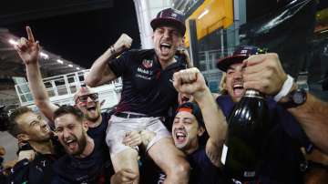 Max Verstappen (centre) celebrates with his Red Bull Racing staff after winning Abu Dhabi F1 Grand P