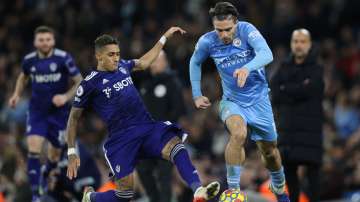 Jack Grealish of Manchester City is challenged by Raphinha of Leeds United during the Premier League