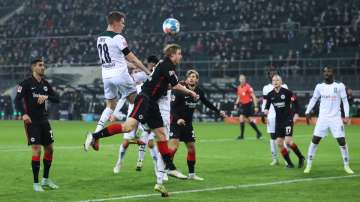 Matthias Ginter of Borussia Moenchengladbach competes for a header with Martin Hinteregger of Eintra