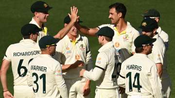 Australia's Mitchell Starc (without cap) celebrates with teammates after taking the wicket of Englan
