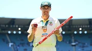 Scott Boland of Australia poses with the Johnny Muller medal, match ball and stump after winning.