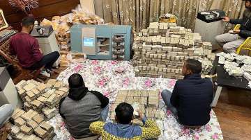 Indian currency retrieved by Income Tax officials from UP businessman Piyush Jains residence during a raid, in Kanpur district, Thursday, Dec. 23, 2021.
