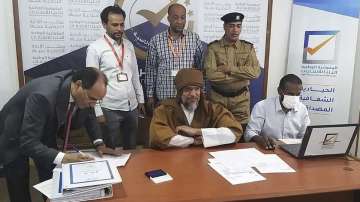 Seif al-Islam, center, the son and one-time heir apparent of late Libyan dictator Moammar Gadhafi registers his candidacy on November 14 for the presidential elections.?