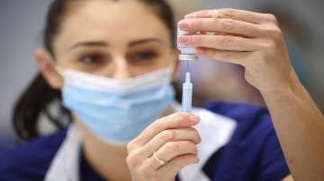 A medical staffer prepares a shot of Moderna COVID-19 vaccine, at a vaccination center in Ramsgate, England.