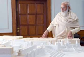 PM Modi looks at the model of the Kashi Vishwanath developmental project.