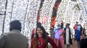 People wearing masks, visit a market at Bandra in Mumbai.