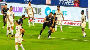 Odisha FC's Hector Ramirez (centre left) and Vinit Rai celebrate after scoring a goal against East B