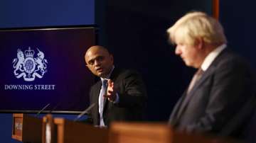 Britain's Health Secretary Sajid Javid, left, and Prime Minister Boris Johnson during a media briefing on the COVID-19 pandemic.