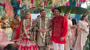 Tej Pratap Yadav with the newly weds at the wedding ceremony. 